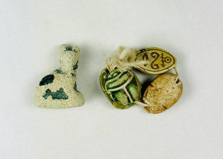 Ancient Egyptian faience cat amulet of Bastet with three scarab amulets, Late Period to Ptolemaic, 600–200 BCE