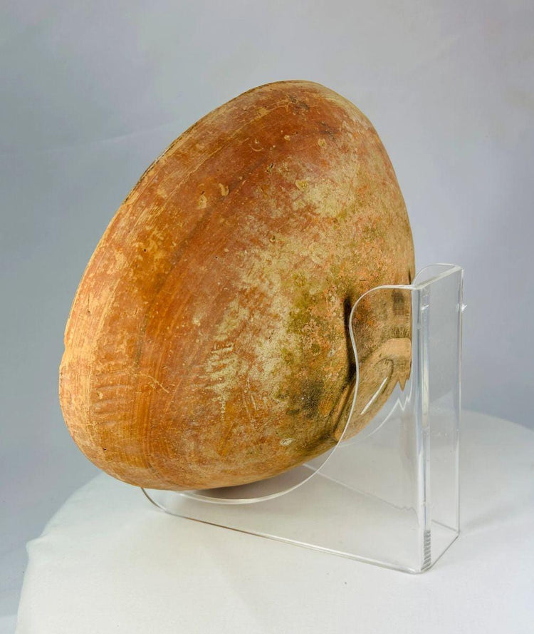 Ancient Indus Valley ceramic bowl with hand-painted geometric decoration on terracotta surface.