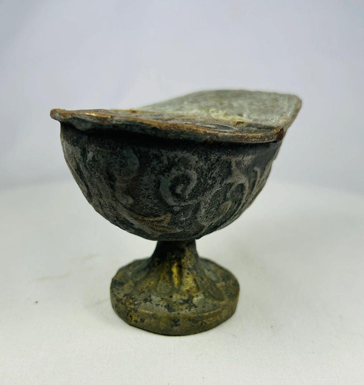 Full frontal view of Han Dynasty bronze lamp, emphasizing pedestal foot, rounded bowl, and swirling decorative motifs.