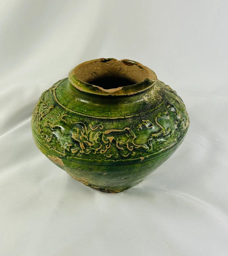 Photo of ancient Han Dynasty pottery vessel showing wear, patina, and glaze variations.