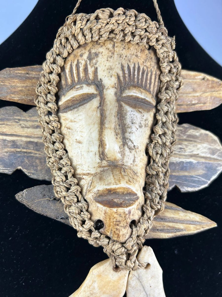 Mid-20th-century Lega pendant mask from Congo with braided fiber and wood backing