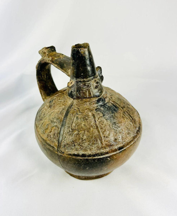 Angled view of Sicán blackware vessel displaying rounded body, burnished finish, and high spout from Lambayeque culture.