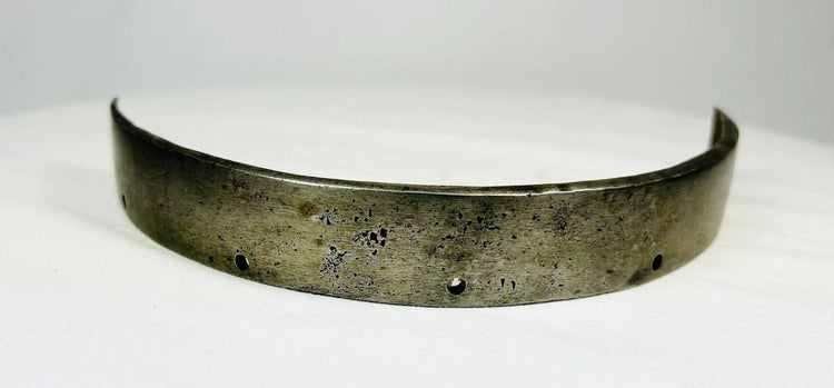 Centre view of armor segment with curved form, reinforced edges, and historical metal craftsmanship.