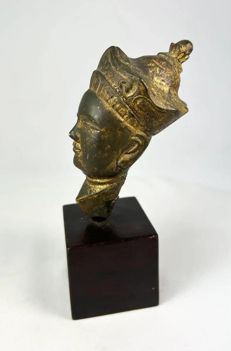 18th–19th century Tibetan gilt bronze Buddha or Bodhisattva head, fragmentary devotional sculpture with calm facial features, decorative crown, and aged patina.