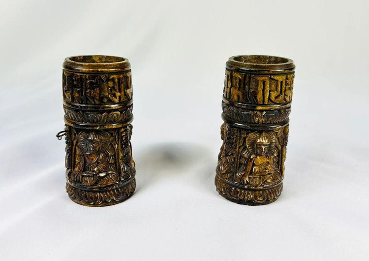 Pair of antique 19th-century Tibetan thigh bone prayer wheel cylinders featuring carved Buddhist deities and Sanskrit mantras, authentic ritual relics from Relic and Rarity.