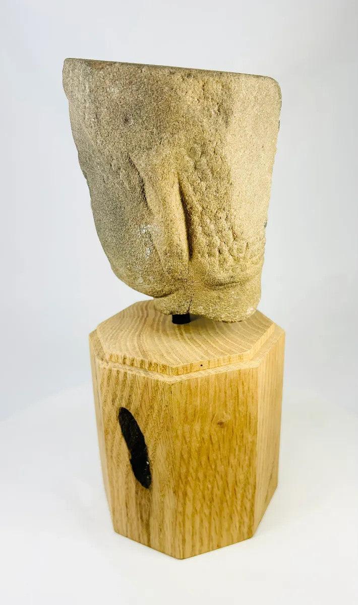 Left-rear angled view of Khmer Sandstone Buddha Head Fragment from 12th-Century Angkor Period Cambodia, highlighting textured hair pattern and aged sandstone patina, mounted on wooden base – Relic and Rarity.