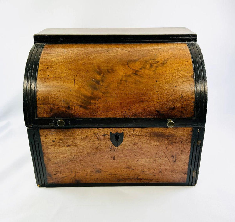 Front view of an early Georgian mahogany spirit box with arched lid and decorative black edging.