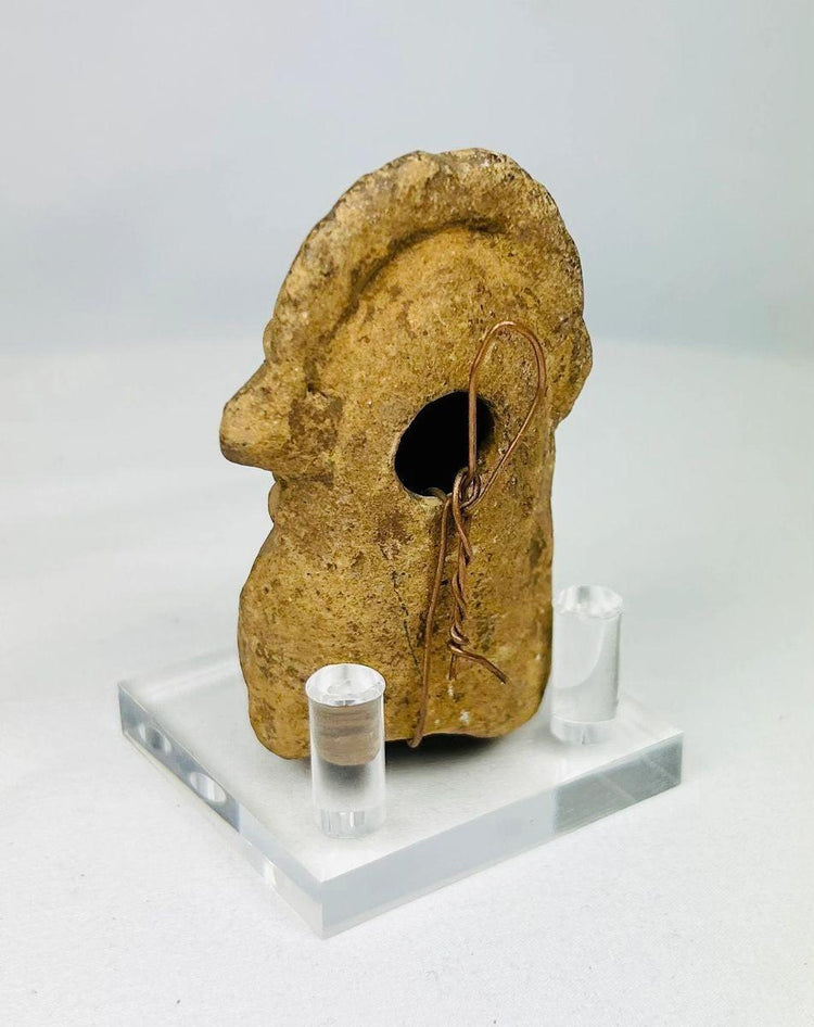 Rear angle of Mesoamerican terracotta sculpture showing sculpted headdress details.