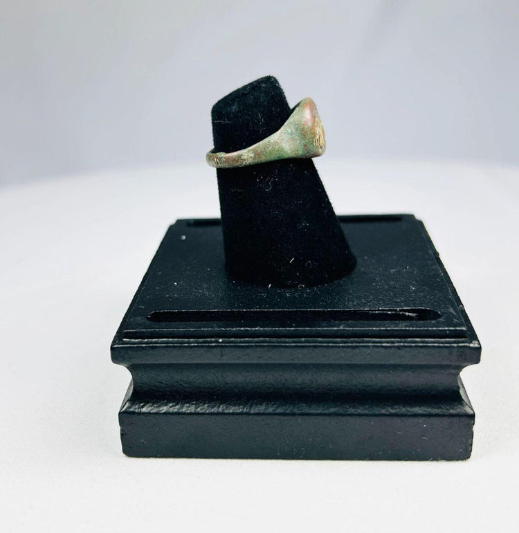 Side view of bronze ring with elephant symbol, historic patina from centuries of aging