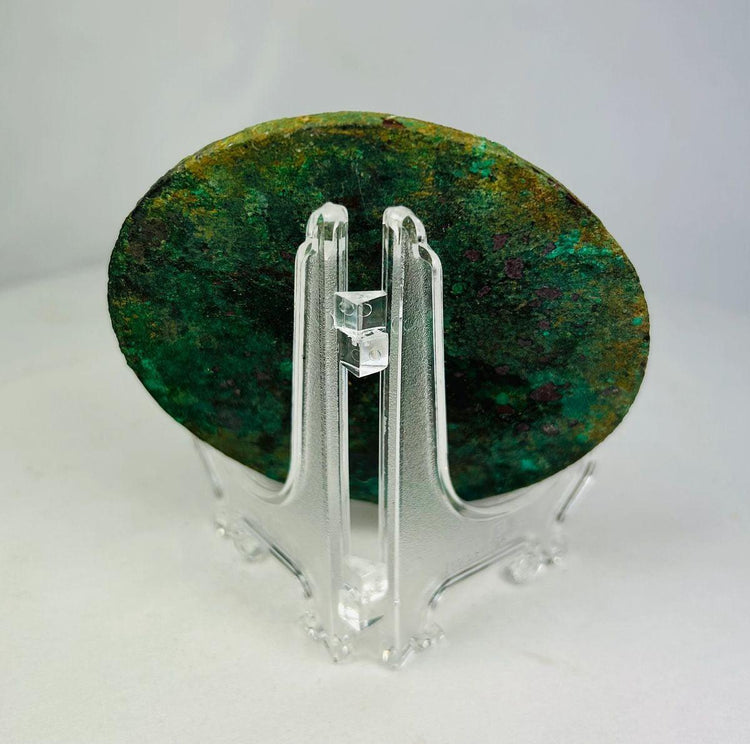 Back view of authentic Han Dynasty bronze mirror with encrusted surface and intricate geometric ornamentation.