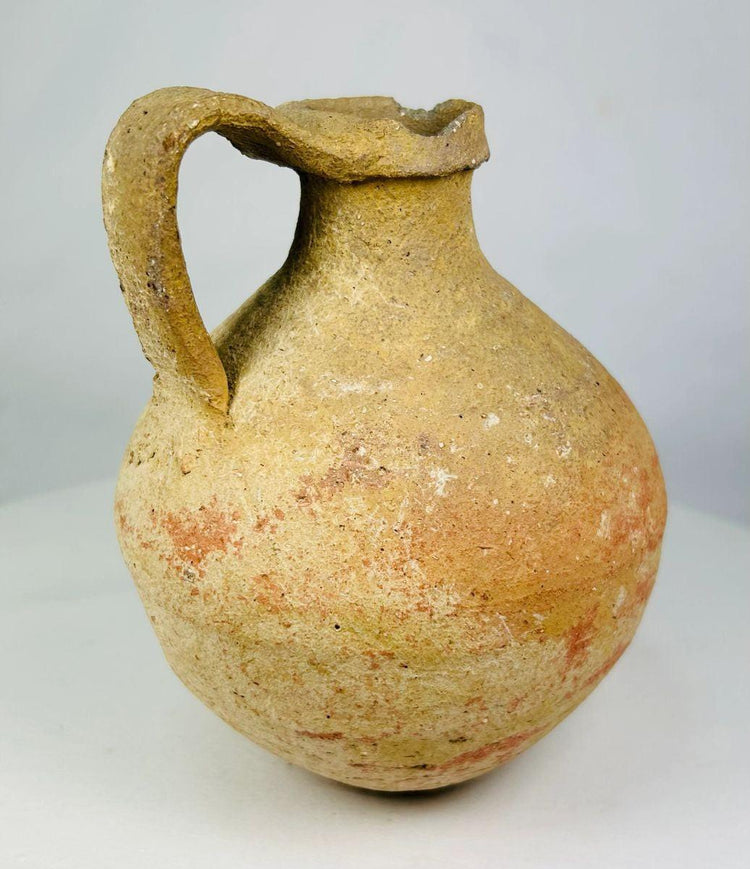 Ancient Egyptian Greco-Roman jug featuring rounded body and spout
