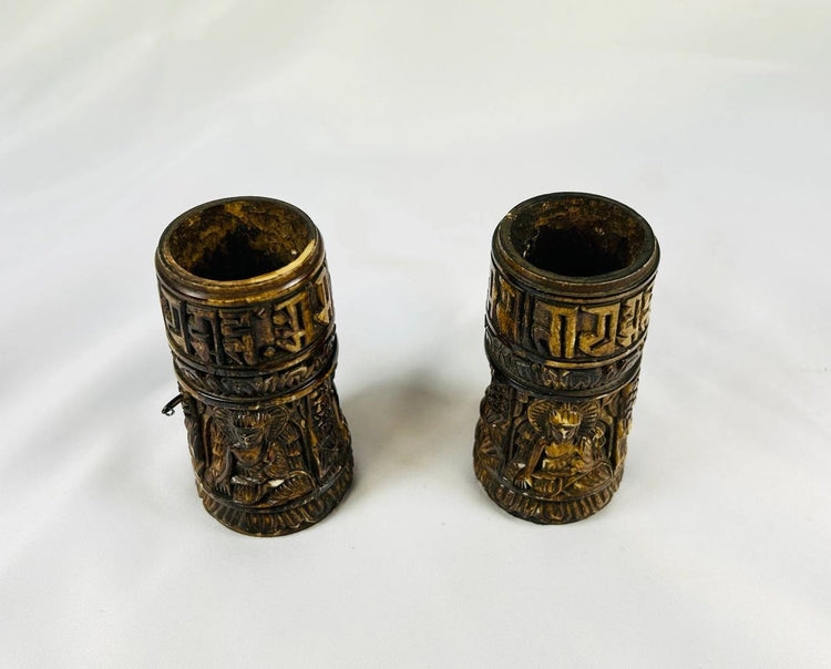 Top view of 19th-century Tibetan thigh bone prayer wheel cylinders showing carved deities and sacred Buddhist inscriptions, authentic ritual artifacts by Relic and Rarity.