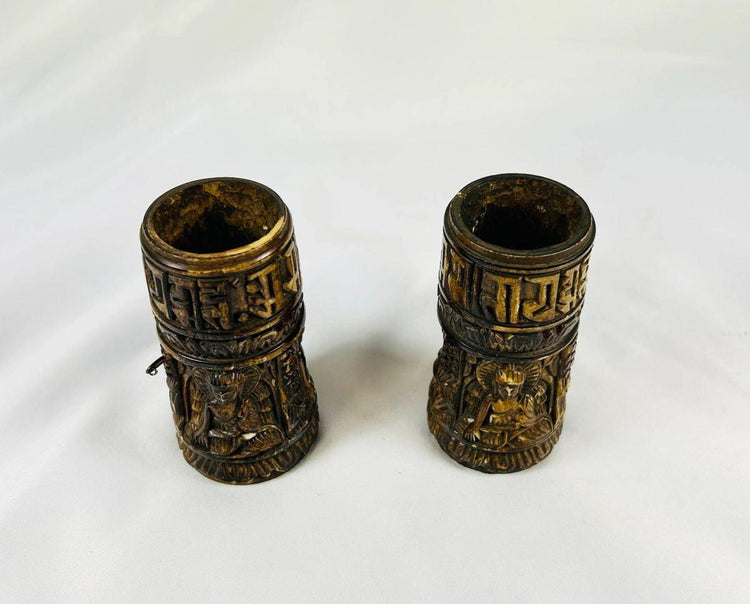 Top view of 19th-century Tibetan thigh bone prayer wheel cylinders showing carved deities and sacred Buddhist inscriptions, authentic ritual artifacts by Relic and Rarity.