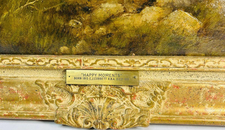 Brass title plaque reading “Happy Moments” on the ornate gilt gesso frame of a Victorian oil painting by Edward John Cobbett R.B.A., English genre artist, circa 1860–1880.