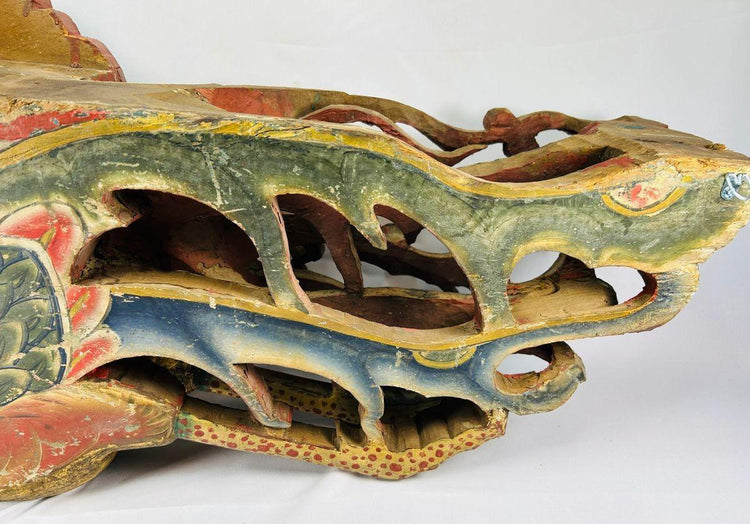 Close-up of Qing Dynasty phoenix relief base section showing intricate openwork carving, red and blue polychrome pigments, and aged camphor wood surface – Relic and Rarity.