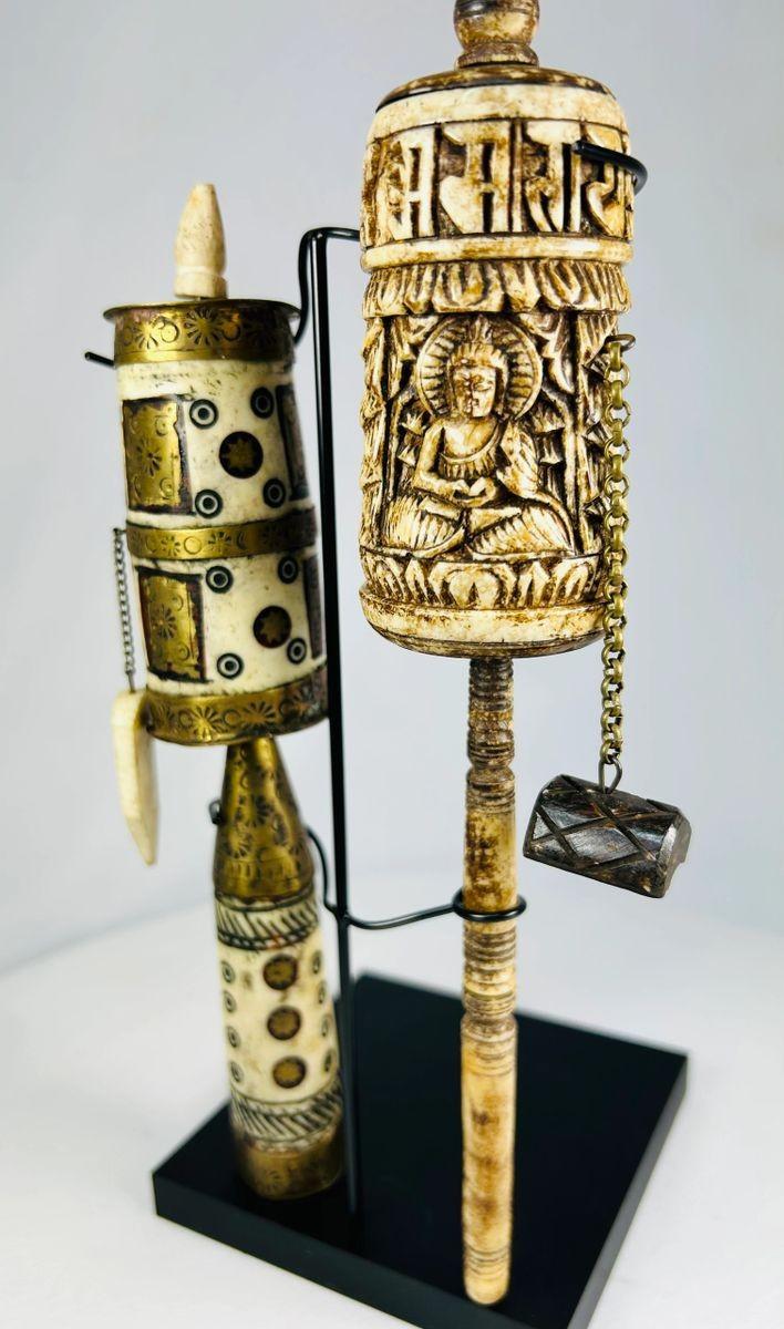 Hand-carved Tibetan Buddhist prayer wheels with floral and sacred designs
