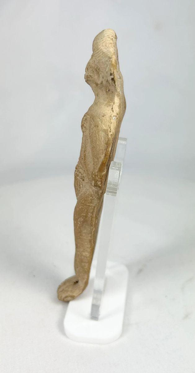 High-resolution image of Roman fertility goddess-style figurine with stylized hair and garment lines.