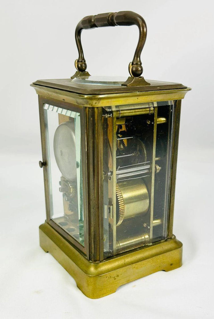 Elegant antique carriage clock by Jules Bunelot with polished brass and enamel detailing.