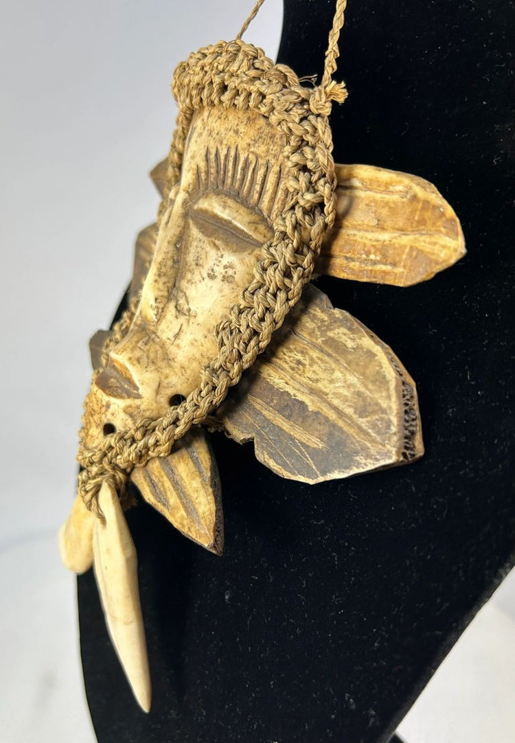 African Lega tribal bone mask with hanging cord mid-20th century