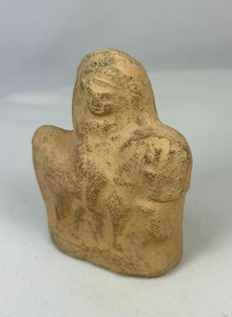 Close-up of Roman Egypt terracotta equestrian figurine showing rider form and texture.