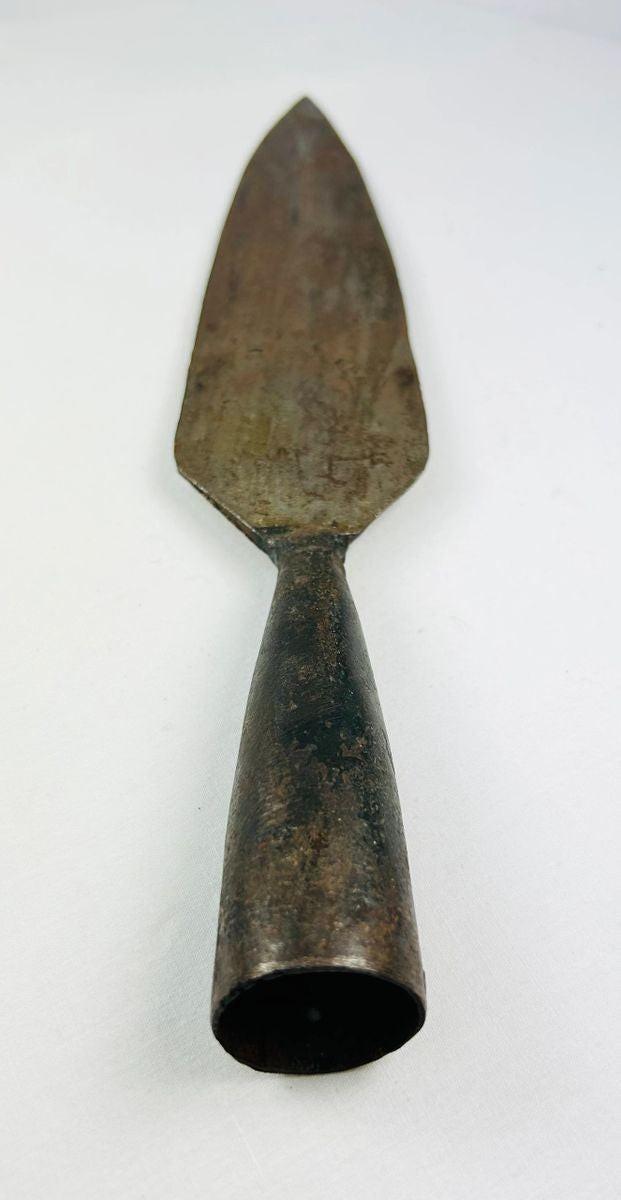 Historical Persian iron spearhead from the 1700s, dark aged surface, white backdrop.