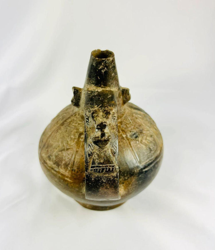 Ancient Sicán Lambayeque blackware vessel showing front view with burnished surface and raised spout, 750–1375 A.D.