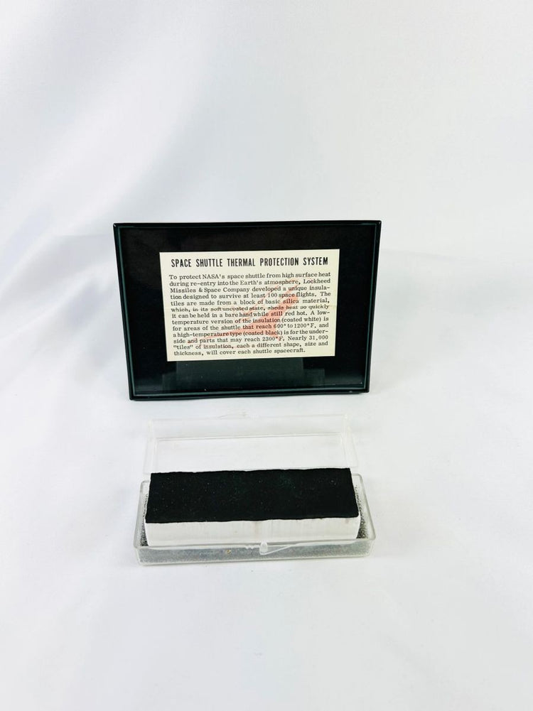 Authentic NASA Space Shuttle thermal protection system tile from the 1980s, displayed in NASA-issued case with documentation. Rare aerospace artifact for collectors.