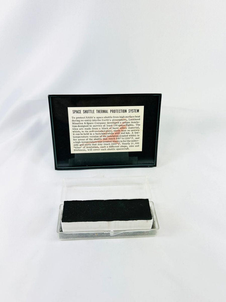 Authentic NASA Space Shuttle thermal protection system tile from the 1980s, displayed in NASA-issued case with documentation. Rare aerospace artifact for collectors.