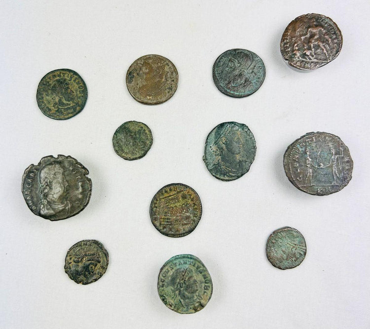 Collection of 12 ancient Roman bronze coins with imperial busts