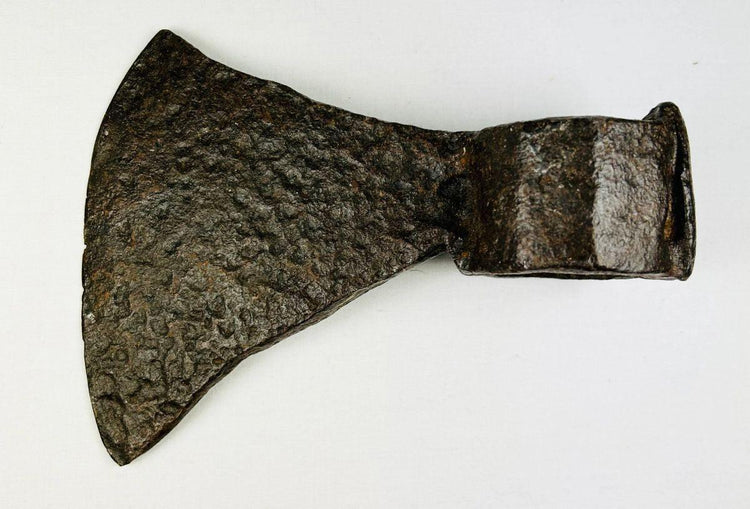 Antique early American iron axe head featuring hand-forged construction and aged surface detail.