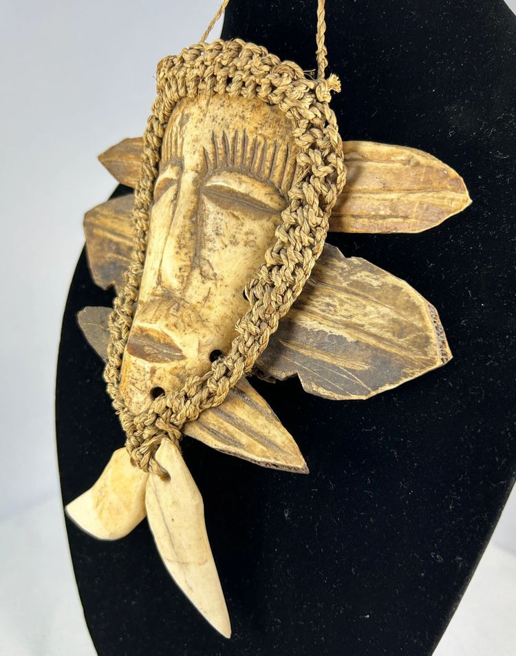Lega tribal mask from Congo with bone face and braided fiber collar