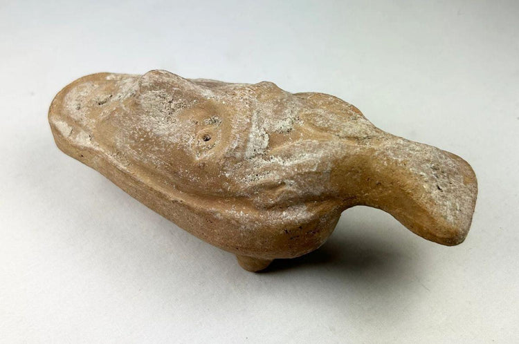 Ancient Byzantine terracotta lamp with worn patina and facial design