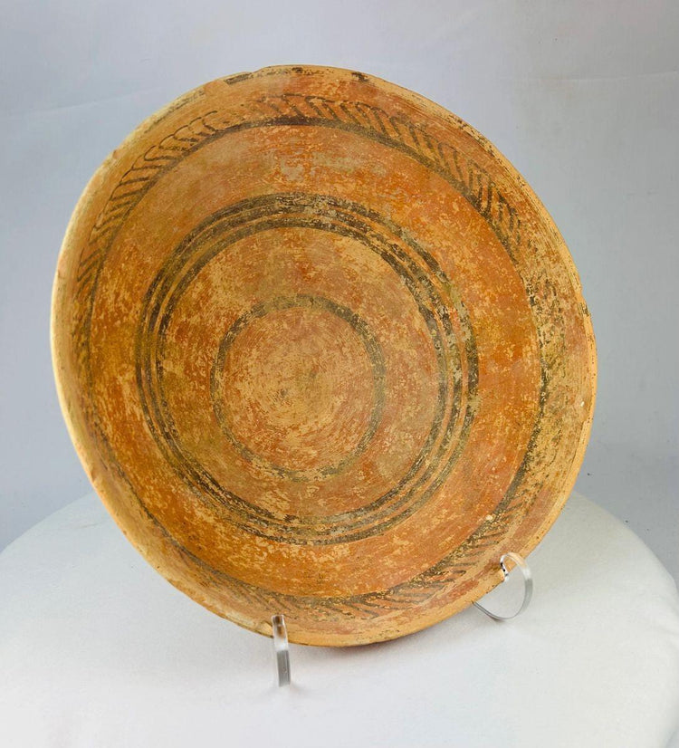 Detailed photo of Harappan painted pottery dish showcasing craftsmanship and cultural symbolism.