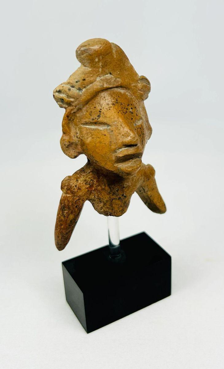 Pre-Columbian terracotta sculpture showing ritual headdress detail