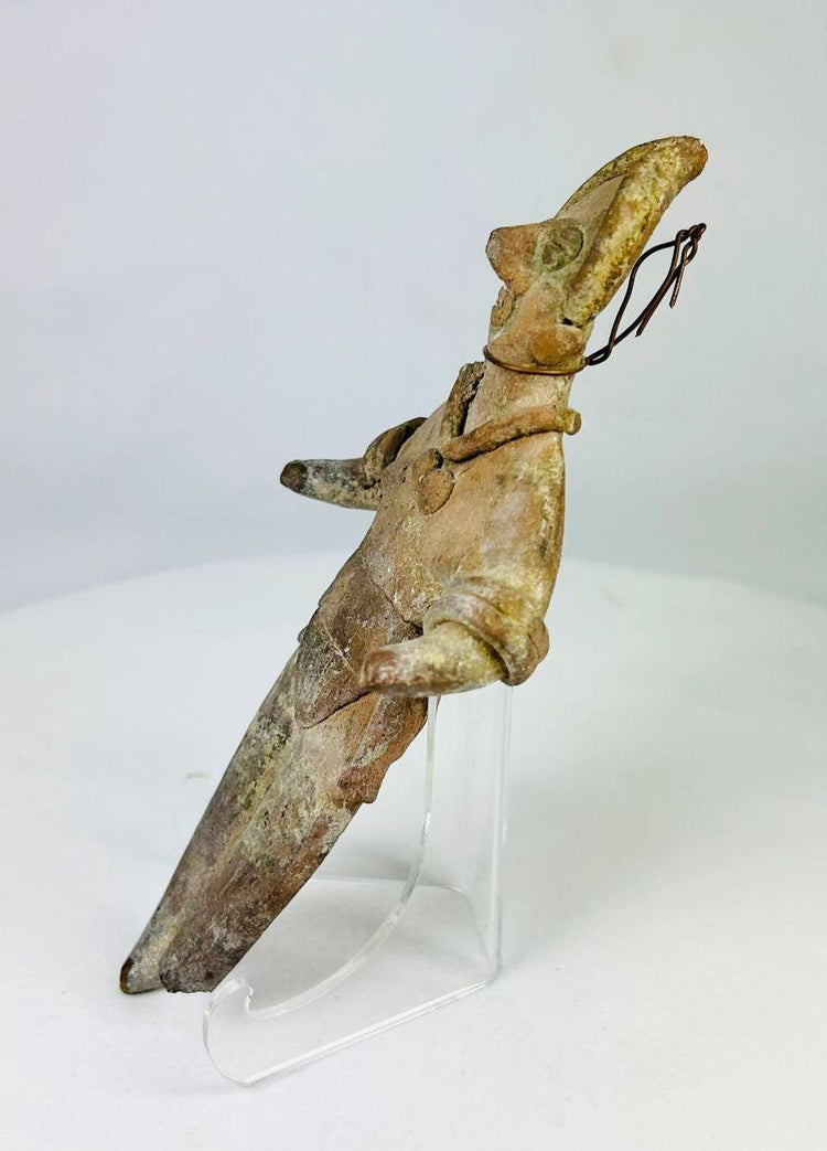 Side profile showing incised torso detailing on a Mesoamerican ritual figurine