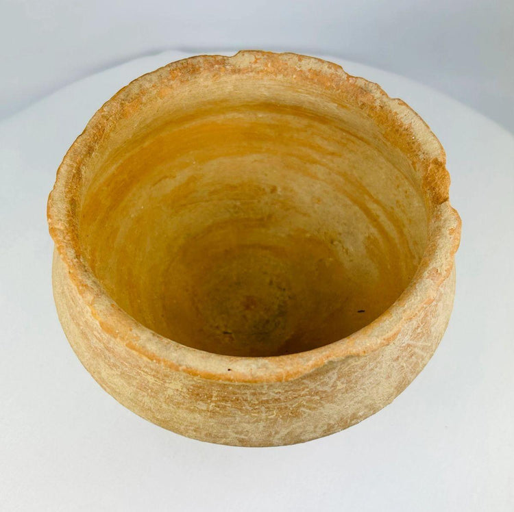 Close-up of Bronze Age terracotta bowl highlighting handmade irregularities