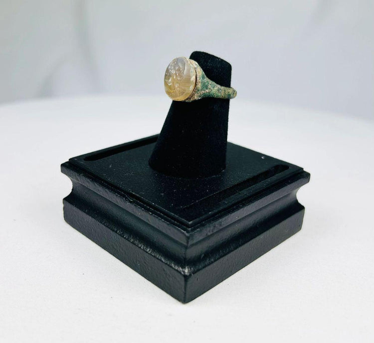 Antique ring featuring bearded male bust in profile on garnet gemstone