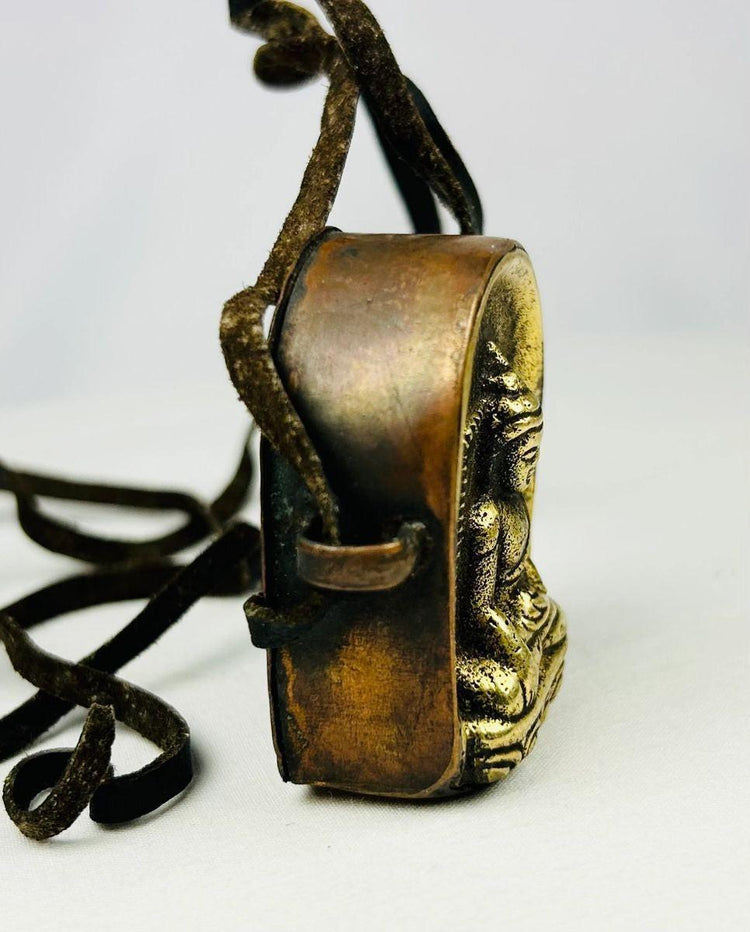 Close-up of gilt bronze Shakyamuni Buddha relief on Tibetan amulet box.