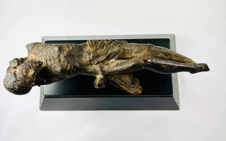 Top view of a 17th-century European wooden crucifix sculpture depicting Christ, hand-carved with Baroque detailing and mounted on a black museum base — Relic & Rarity.