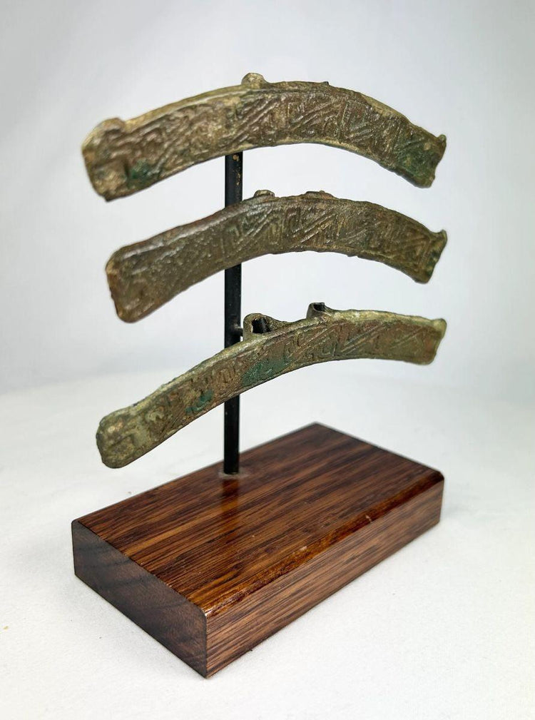 Warring States to Han Chinese bronze fittings with curved decorative form