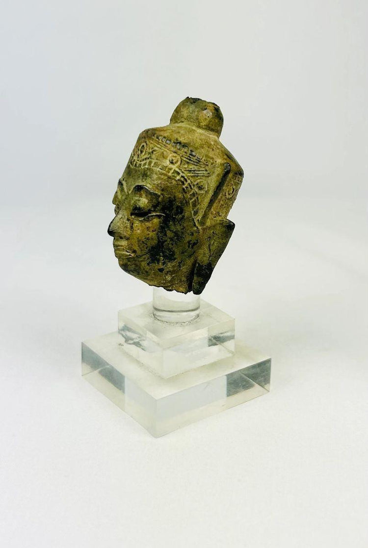 Museum-style presentation of a Southeast Asian bronze Buddha head