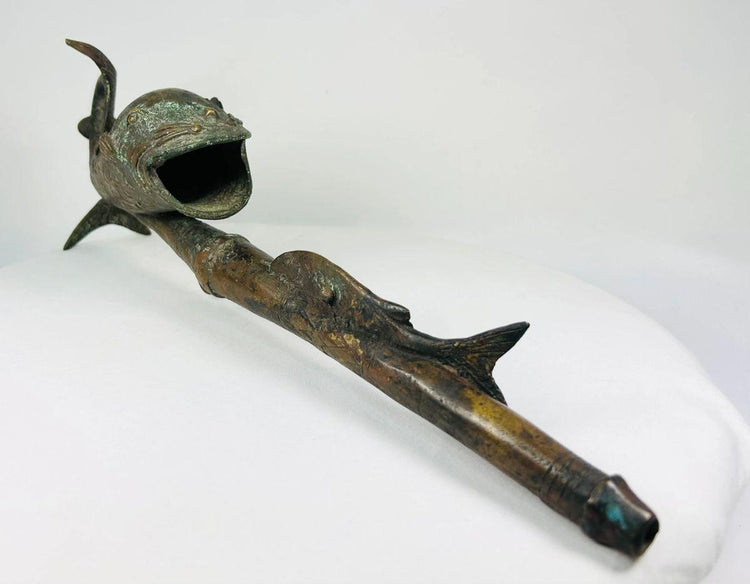 Bronze fish-shaped pipe from Cameroon shown against white background