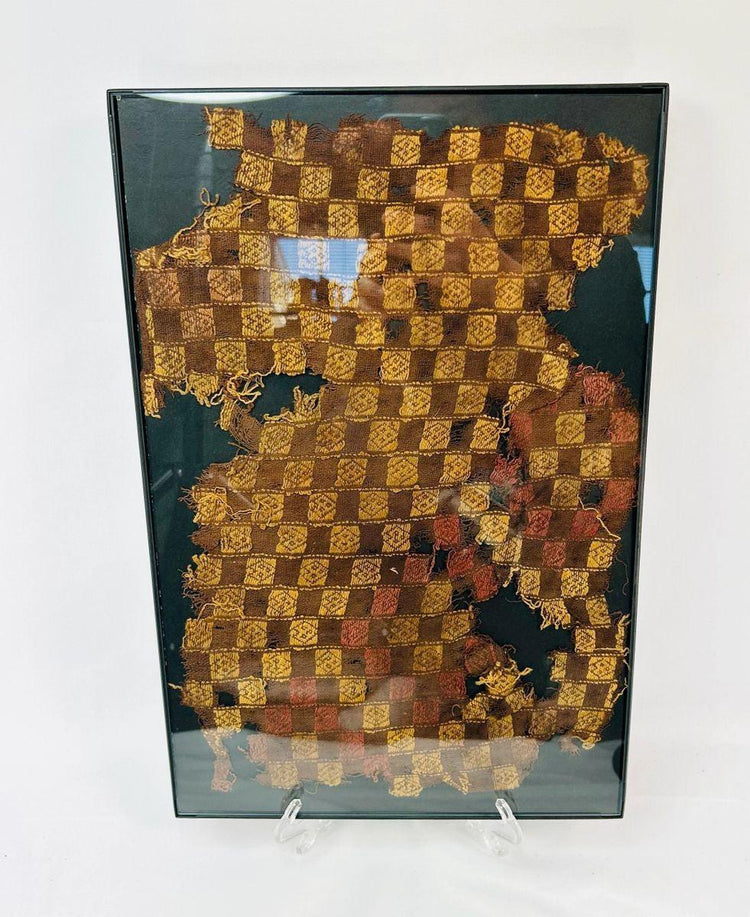 Close-up of Pre-Columbian Chancay textile showing fine cotton fibers and symbolic patterning.