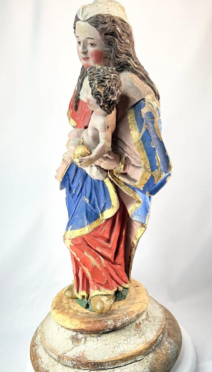Historic Madonna and Child santo, carved wood with surviving gilded accents and polychrome paint, over 200 years old devotional artwork.