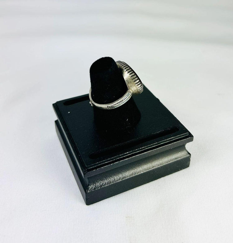 Oval red carnelian intaglio ring from Ancient Near East, 1st millennium BCE, detailed engravings, displayed on black stand