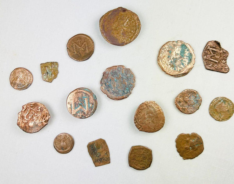 Close-up view of Roman and Byzantine bronze coins with natural patina and circulation wear