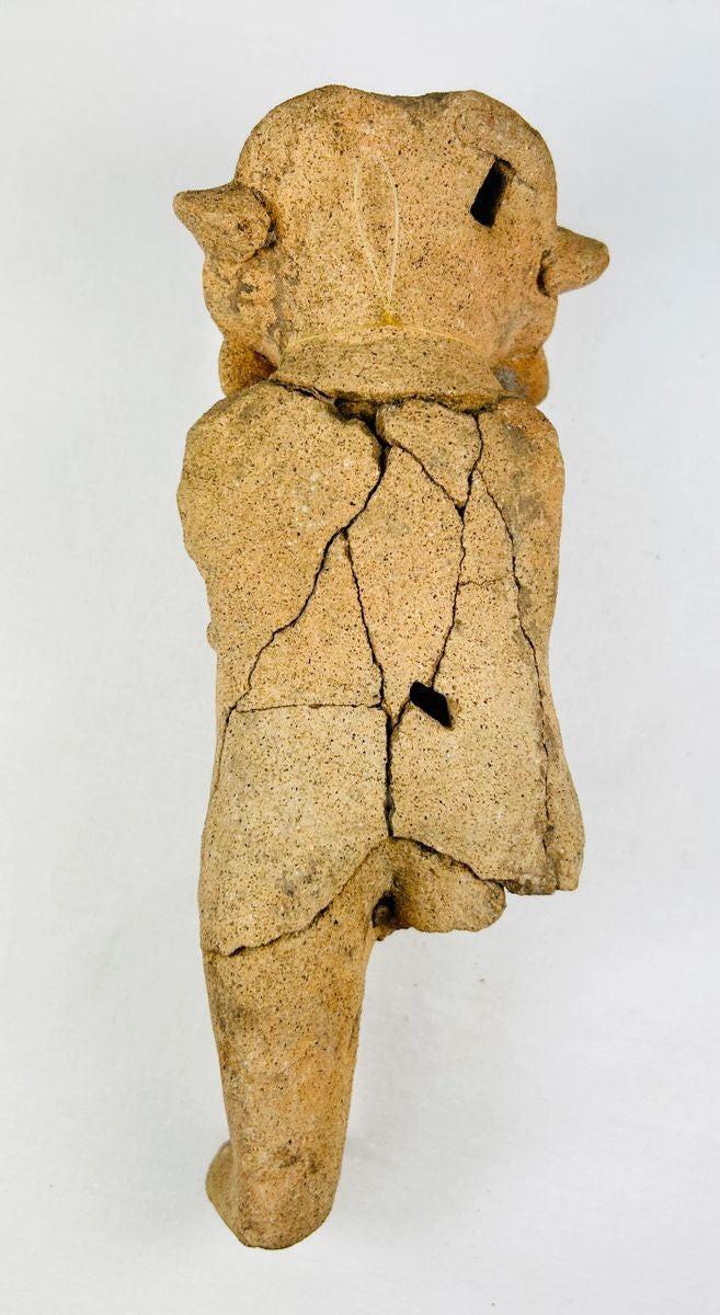 Detail view highlighting facial features and surface texture of a Pre-Columbian figurine