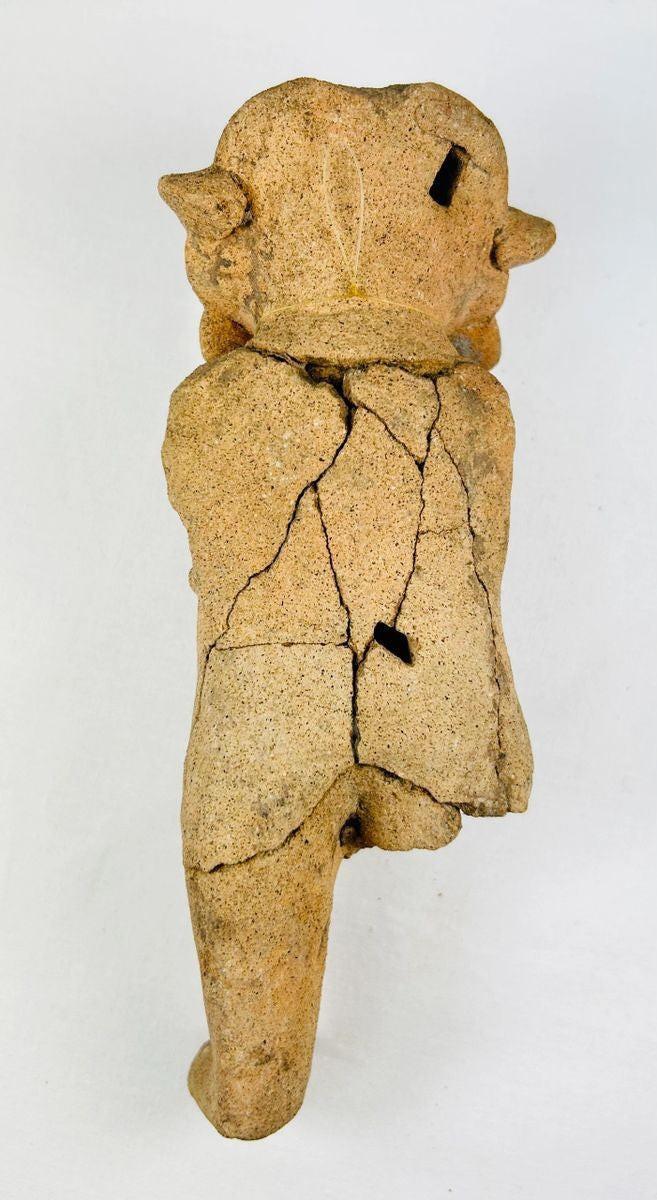 Detail view highlighting facial features and surface texture of a Pre-Columbian figurine