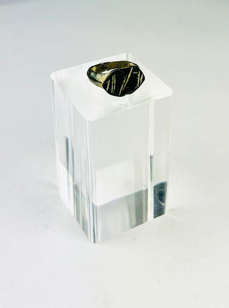 Close-up of an engraved Roman bronze personal seal ring with linear intaglio design