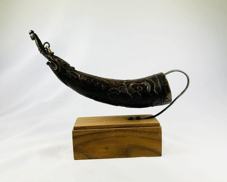 Historic Tibetan mustard seed dispenser carved from horn, angled view.